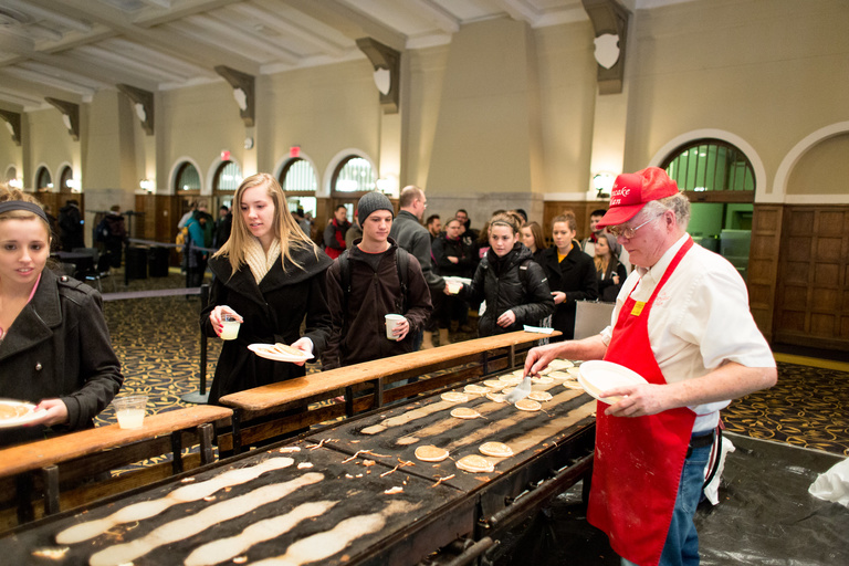 handing out pancakes to iowa students