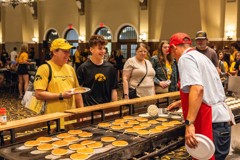 families lining up for pancakes at family weekend in iowa city