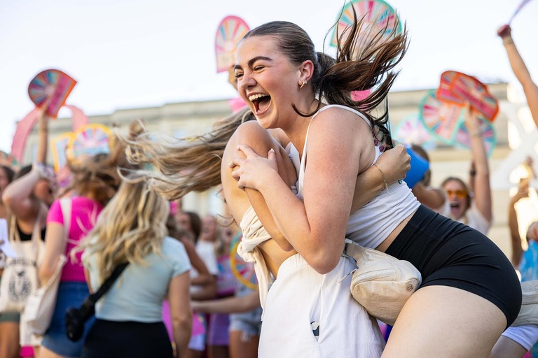 A new sorority member celebrates with another member during the PHC's Bid Day