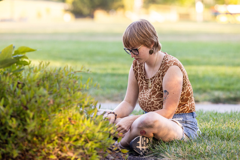 Student sitting in grass with the Earthmind workshop