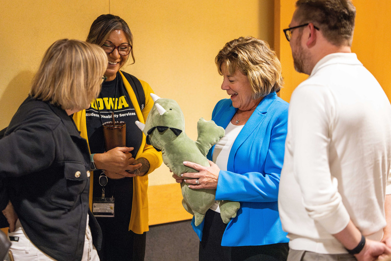 President Wilson admires a stuffed animal before giving remarks at an open house for the Student Disability Services Lounge.