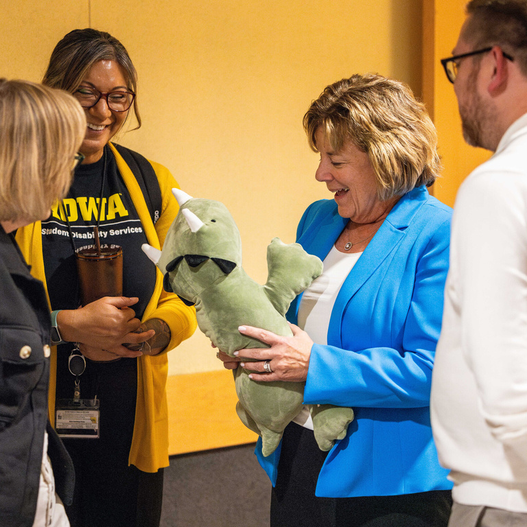 President Wilson admires a stuffed animal before giving remarks at an open house for the Student Disability Services Lounge.