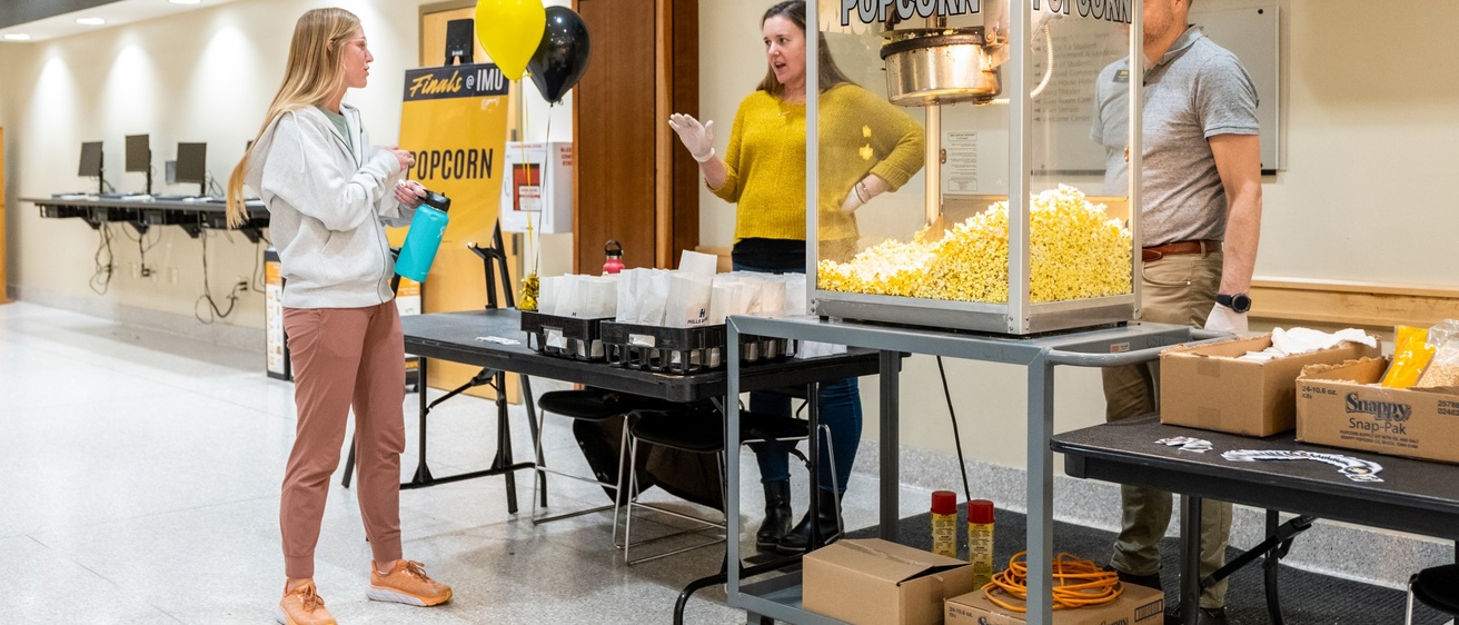 People serving popcorn in the IMU