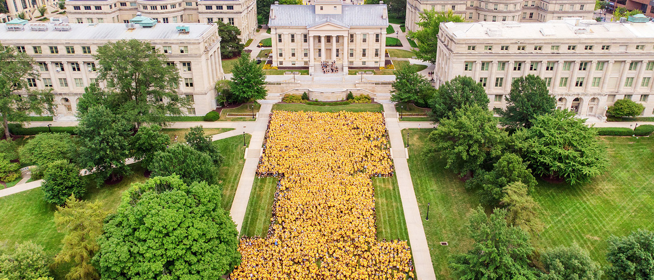 An overhead view of a bunch of people forming the block "I" on the Pentacrest
