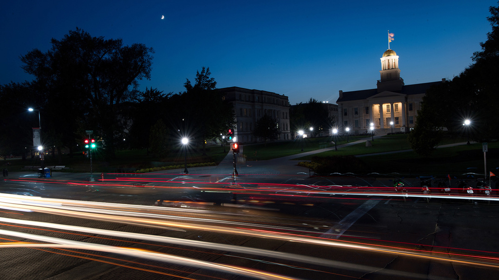 image of car lights in front of the old capitol