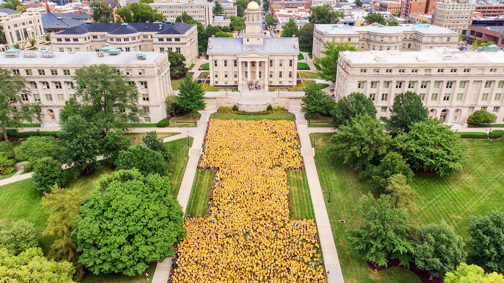 An overhead view of a bunch of people forming the block "I" on the Pentacrest