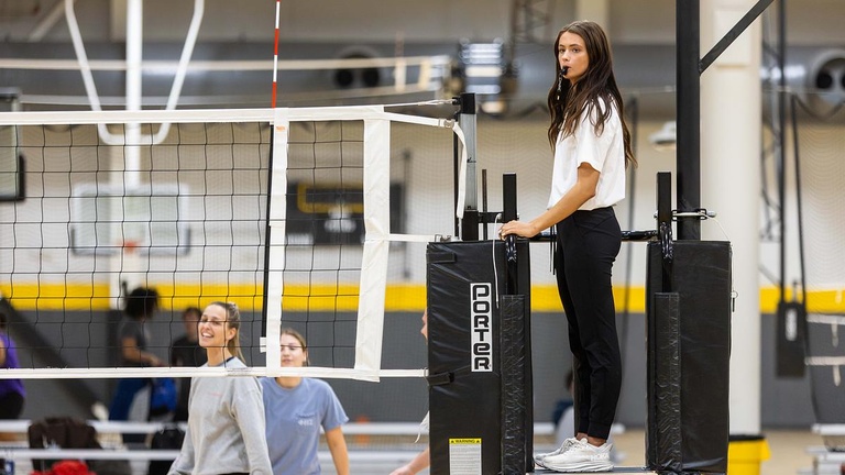 Student referees officiate matches of intramural volleyball.