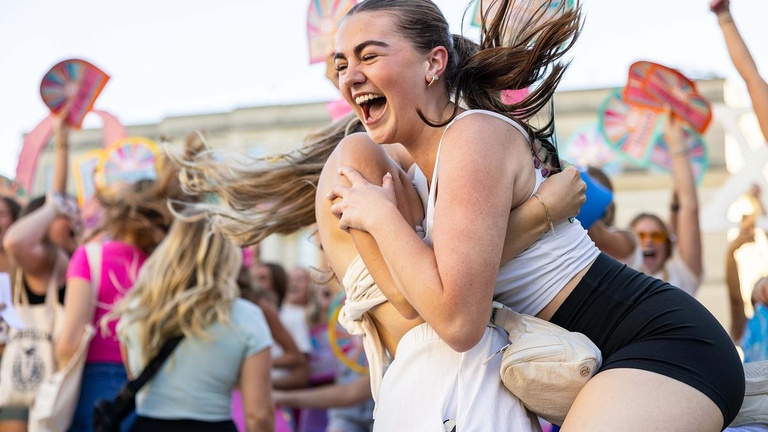 A new sorority member celebrates with another member during the PHC's Bid Day